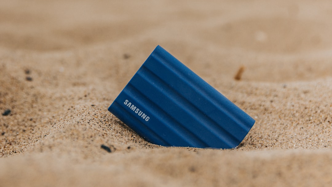 Portable Samsung SSD in beach sand